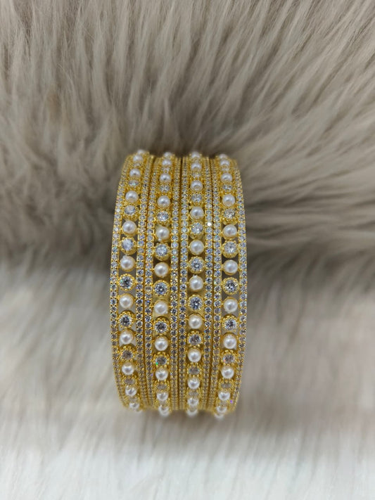 Zirconia AD Gold pearl bracelet Bangle with pearls and crystals on a fur background