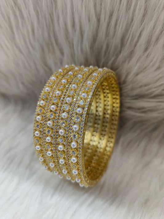 Zirconia AD Gold Pearl Bangle bracelet on a fur background