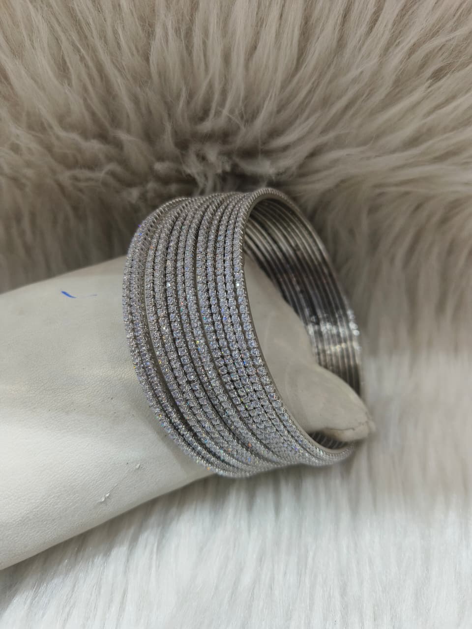 Zirconia Silver Bangles on a fury background