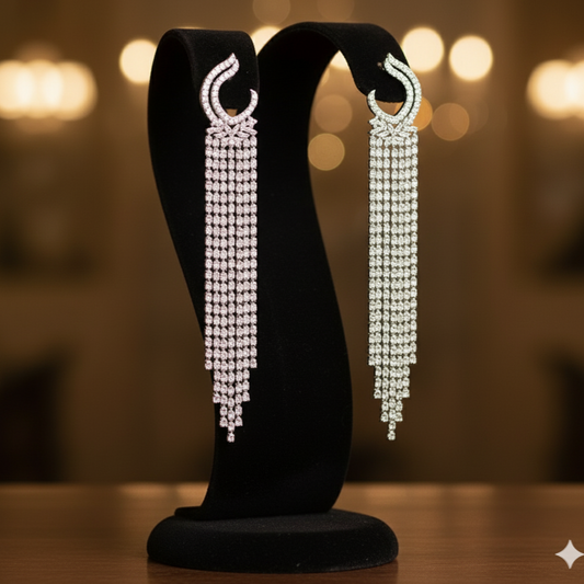 Pair of long, Zircon earrings on a black stand 